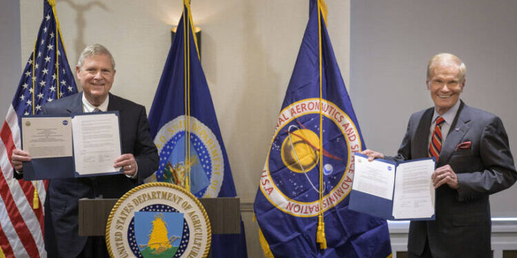 U.S. Secretary of Agriculture Thomas Vilsack, left, and NASA Administrator Bill Nelson, pose for a photograph after having signed a memorandum of understanding, Wednesday, June 21, 2023, at the USDA’s Jamie L. Whitten Building in Washington. The agreement strengthens the collaboration between the two agencies, including efforts to improve agricultural and Earth science research, technology, and agricultural management, as well as the application of science data and models to agricultural decision making.