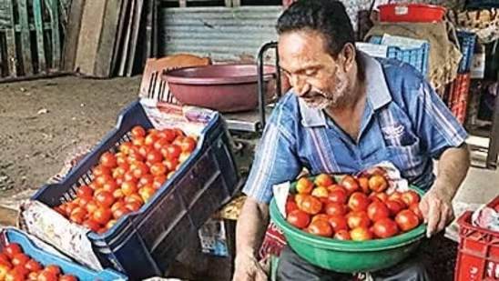 A vendor sorts tomatoes at a market, in Nagpur on Thursday.